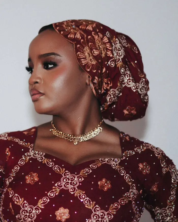 Woman in a gele and embroidered dress