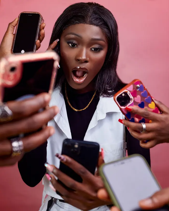 Woman reacting with surprise as phones show her clip