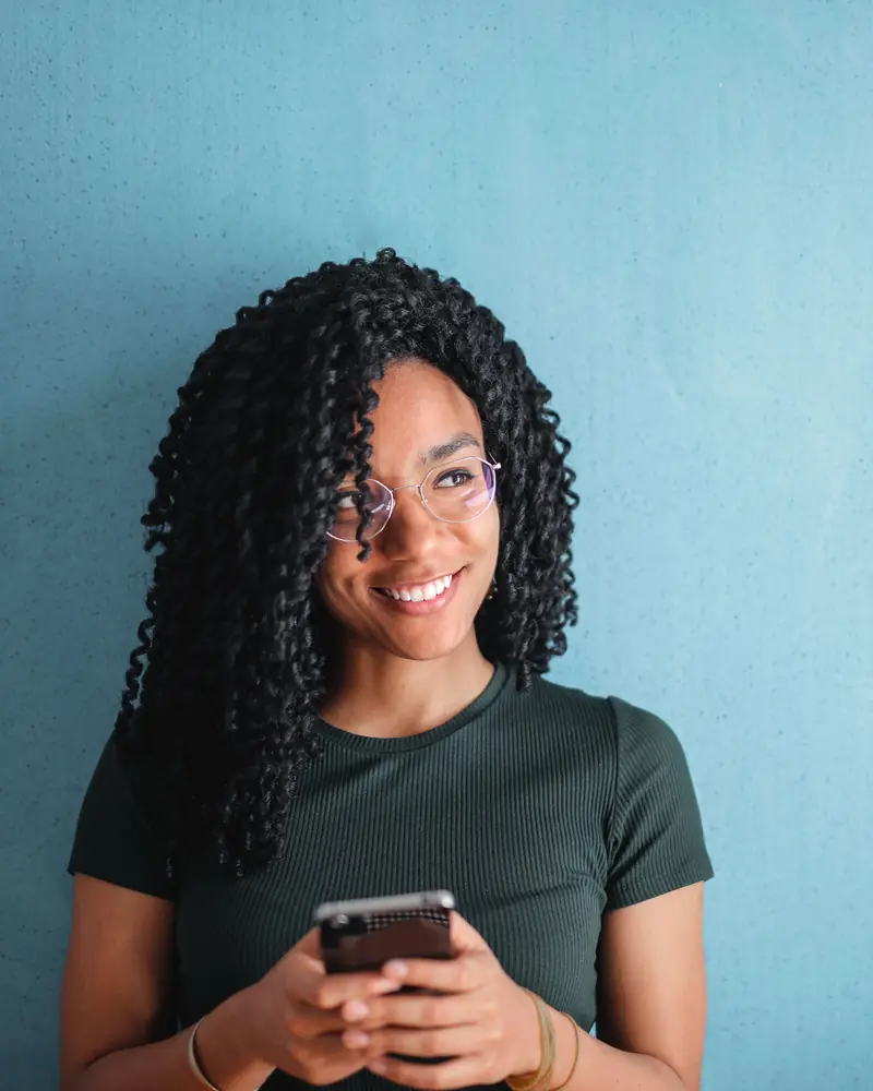 Clipper smiling while browsing campaigns on her phone